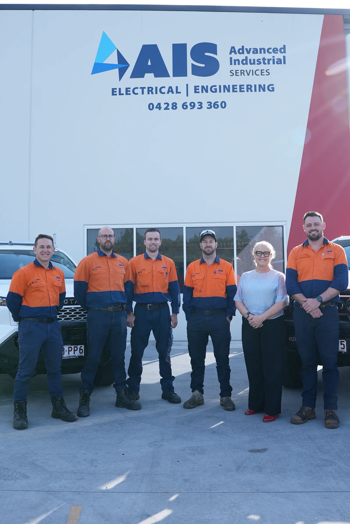 Six AIS team members outside the Advanced Industrial Services workshop