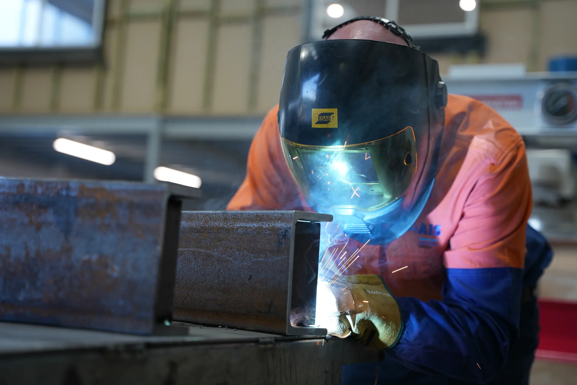 AIS fabricator welding a steel component in the workshop